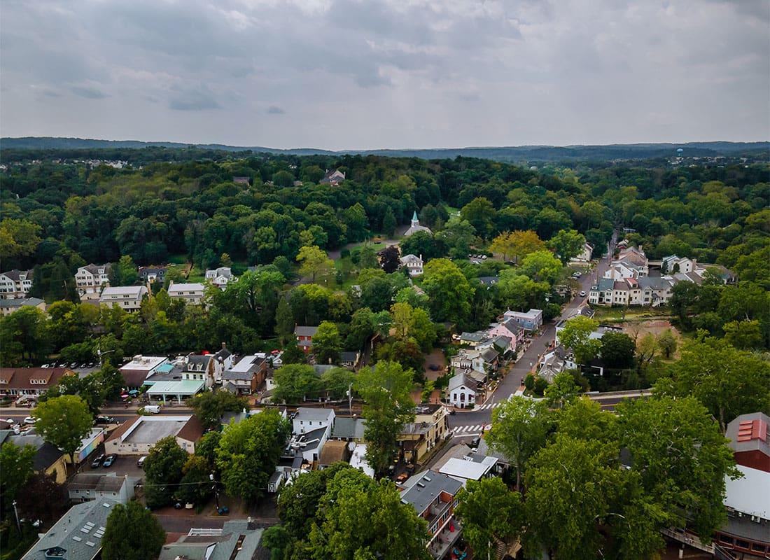 Media, PA - Aerial View of Homes and Buildings Surrounded by Green Foliage in Media Pennsylvania on a Cloudy Day